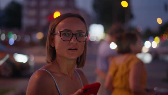 Young Woman Sending Text Message in Night City