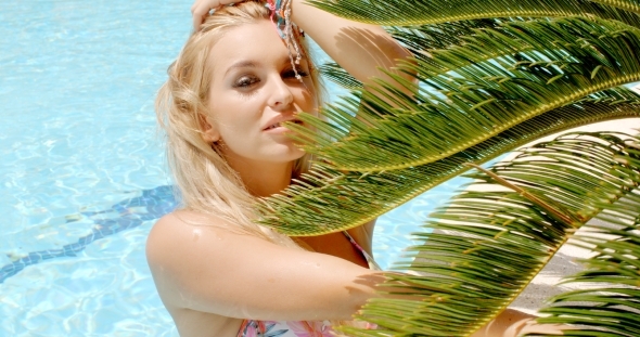 Sensual Woman In The Pool Beside Palm Leaves alt