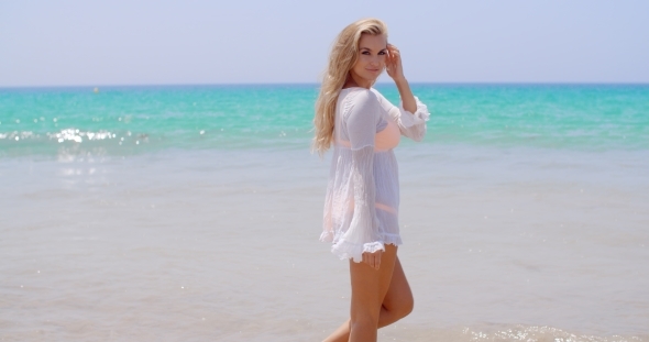 Pretty Young Woman Standing Against Ocean alt