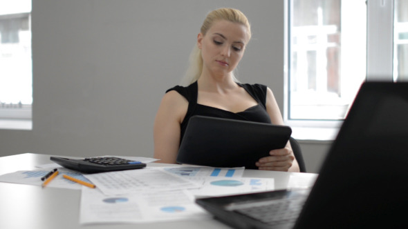 Businesswoman Reading on Tablet