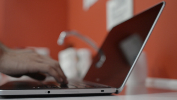  Typing on Laptop in Kitchen alt