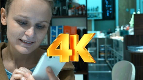 Typing Sms On Cell And Having Coffee In Cafe alt