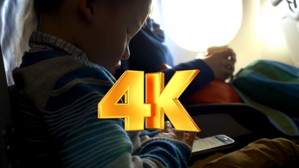 Little Child In Plane Using Smartphone alt