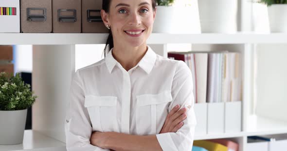 Young Woman Standing Near Shelving with Folders of Documents and Smiling  Movie