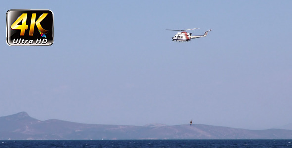 Helicopter is Holding Diver and Sea alt