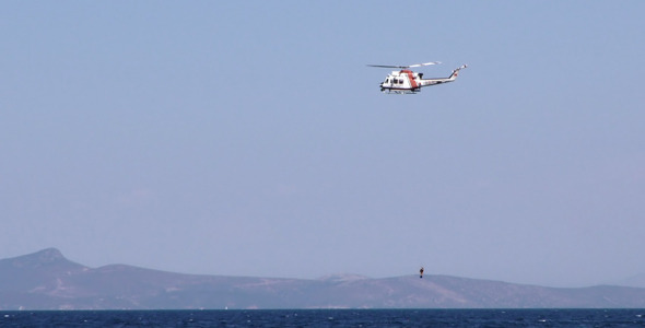 Helicopter is Holding Diver and Sea alt
