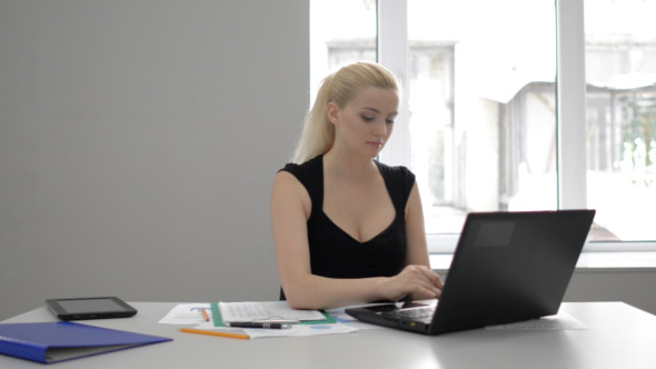 Businesswoman typing on Laptop at Work