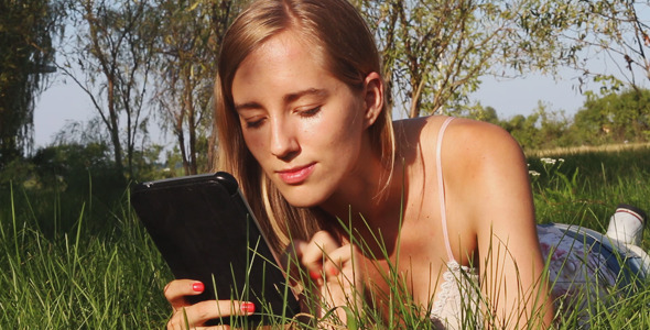 Girl Using a Tablet in the Park