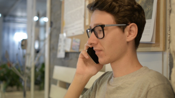 Excited Young Man on Phone alt