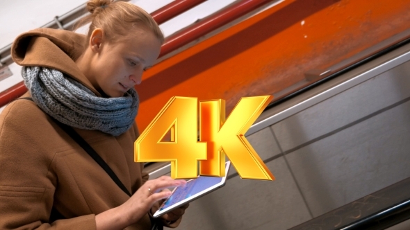 Timelapse Of Woman With Pad Riding On Escalator alt