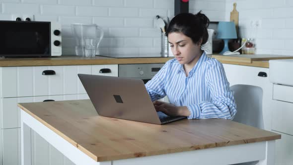 Smiling Indian Girl Student Typing On Laptop Preparing Course Work