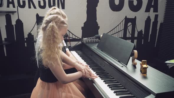 Two Cute Blonde Girls with Blond Eyes Setra Play the Piano Together