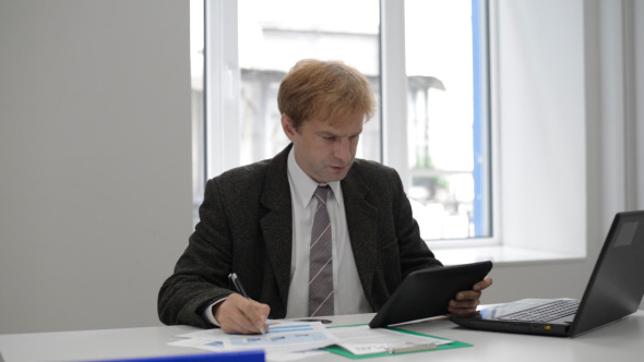 Businessman Using Tablet and Working