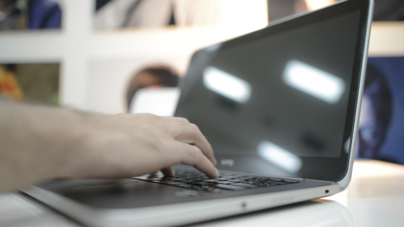 Typing on Laptop Keyboard in Office