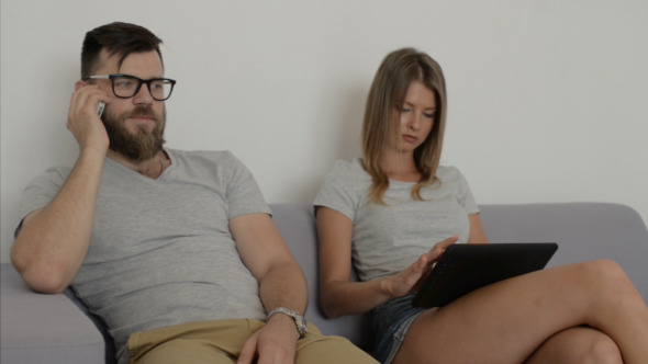Couple, Girl Using Tablet, Man Talking on Phone alt