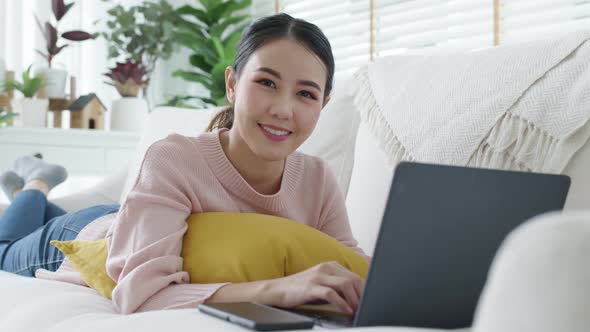 Portrait asian woman lying down on sofa