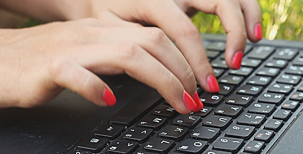 Girl Typing on a Laptop Keyboard alt