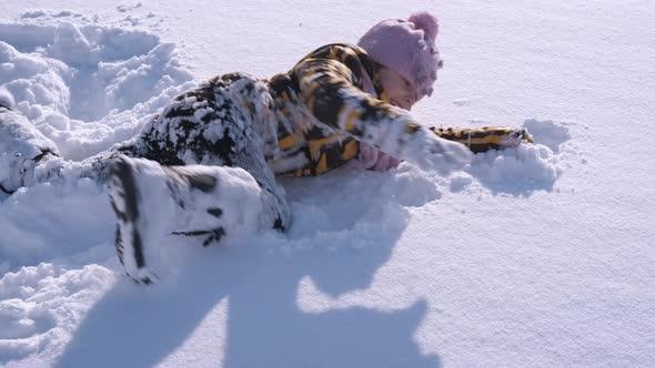 Child Play in Fluffy Snow