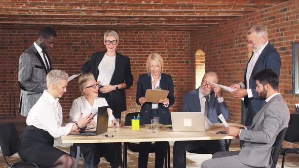 Group of Business People Brainstorming Together in Meeting Room