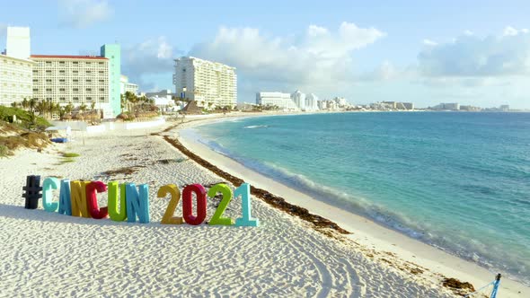 Aerial View of the Cancun 2021 Sign Hashtag on the Beach in Mexico