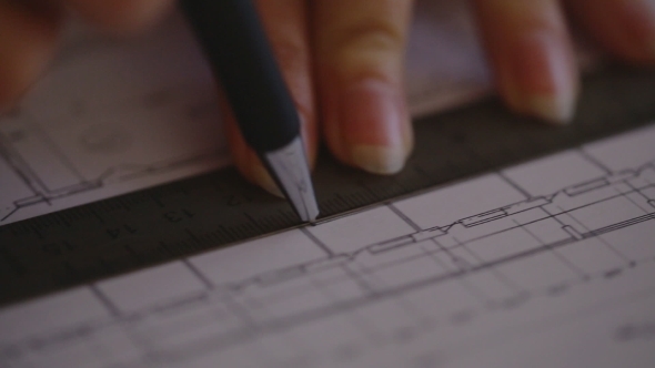 Young Female Architect Working At Desk On