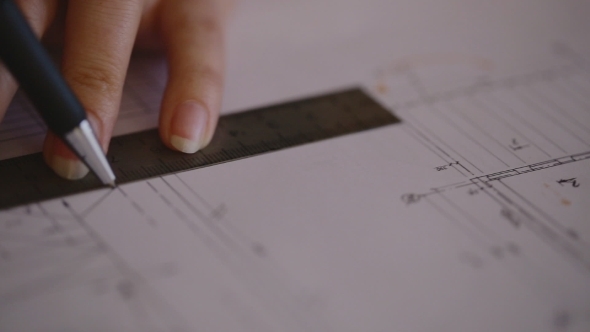 Attractive Young Female Architect Working