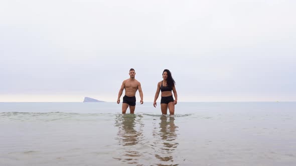 Multiethnic sportspeople on beach during training