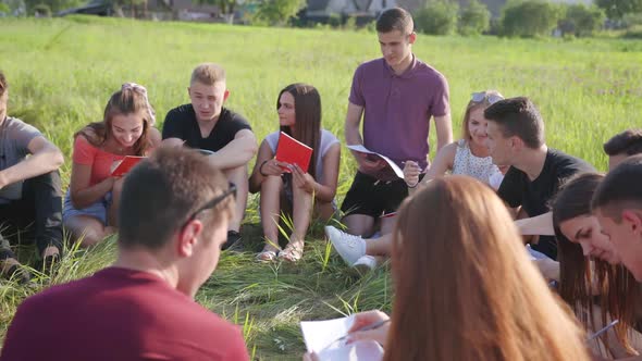 Teamwork of Friendly Students on the Grass