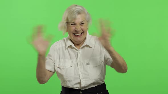 An Elderly Woman Shows Amazement, Joy and Smiles. Old Grandmother. Chroma Key