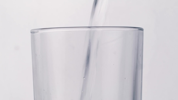 Pouring Water On Glass On White Background