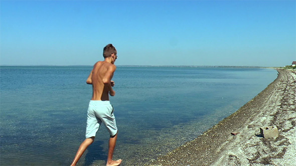Two Guys Run Along the Seashore