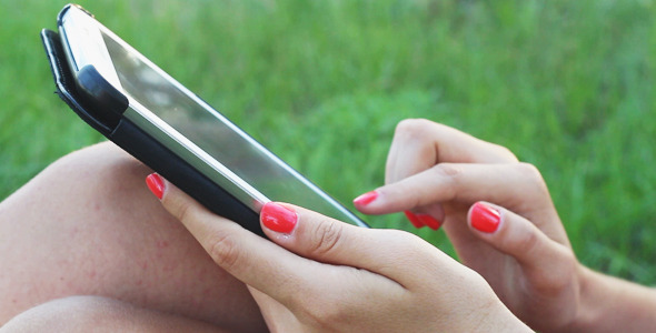 Girl Using Touchpad on the Nature alt
