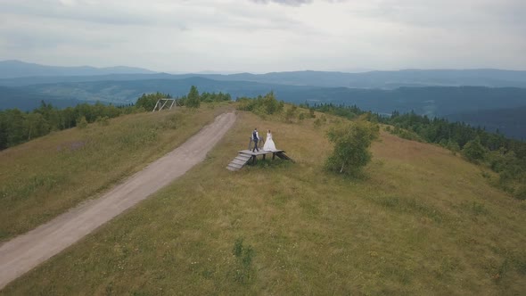 Groom with Bride Together on a Mountain Hills. Aerial Drone Shot