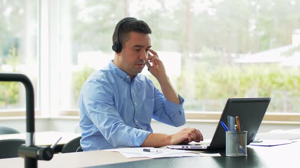 Man with Headset and Laptop Working at Home