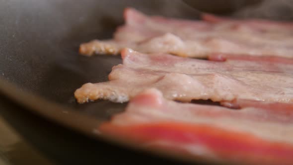 Sizzling Bacon in Frying Pan