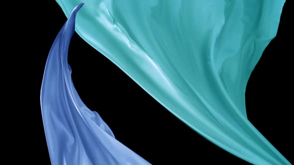 Blue and green color fabrics flying in midair, Slow Motion