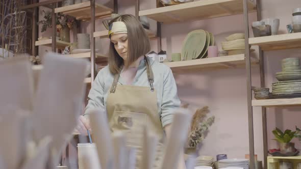 Good-looking Craftswoman Working in Pottery