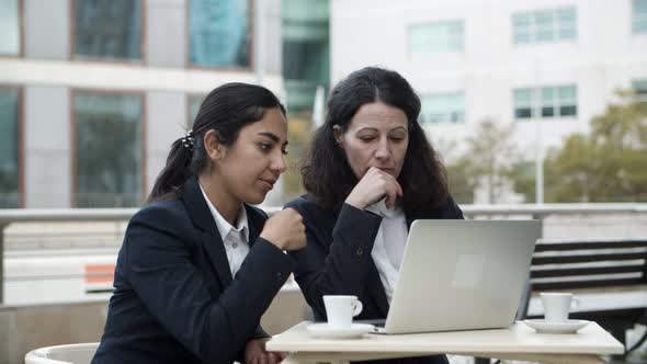 Businesswomen Working with Laptop in Cafe