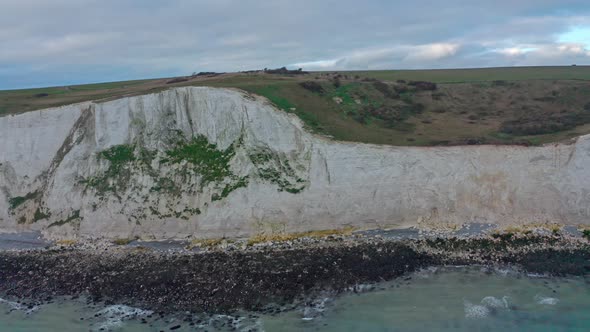 Aerial profile drone shot along the white cliffs of dover on a cloudy day