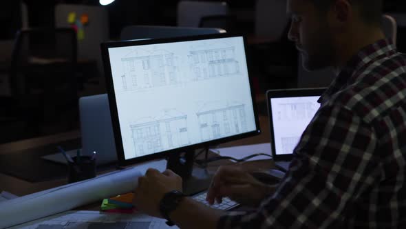 Businessman working in a modern office by night