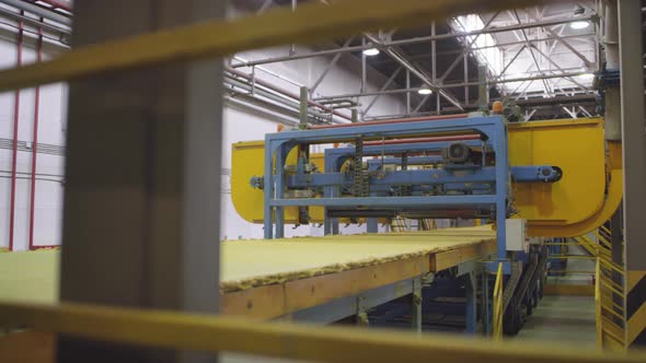 Raw Rockwool Mass Moving on Conveyor Belt during Manufacturing Process