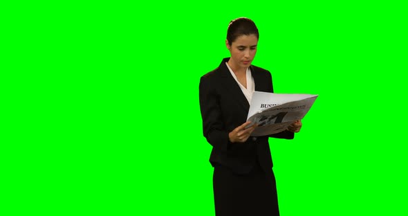 Businesswoman reading newspaper