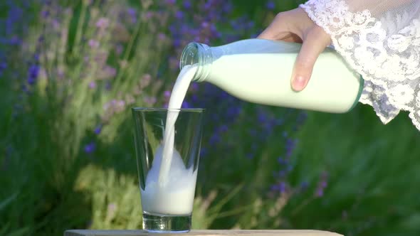 Organic milk pour from bottle outdoors