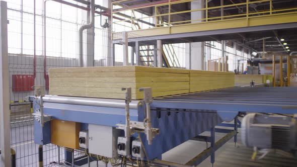 Stacked Slabs of Mineral Wool Moving along Automated Conveyor Belt