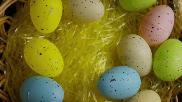 Rotating Shot of Easter Decorations and Candy in Colorful Easter Grass