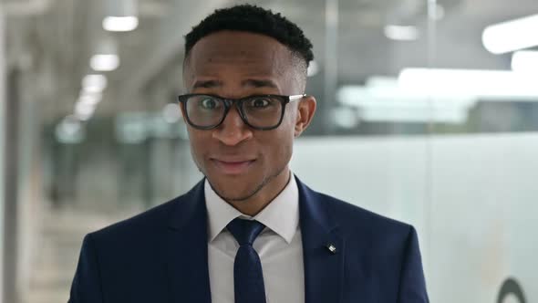 Portrait of Happy Young African Businessman with Pointing with Finger