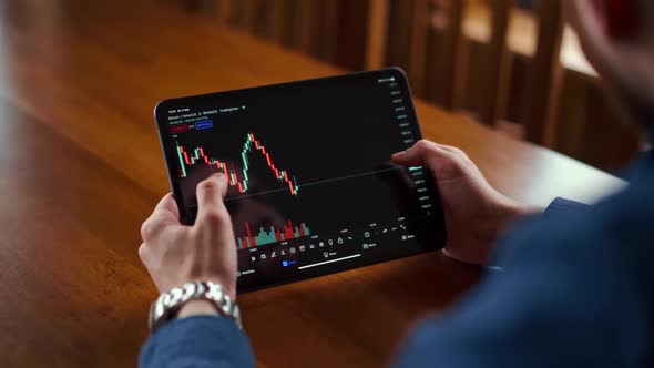 Businessman checking bitcoin price chart on digital exchange on mobile phone screen, cryptocurrency