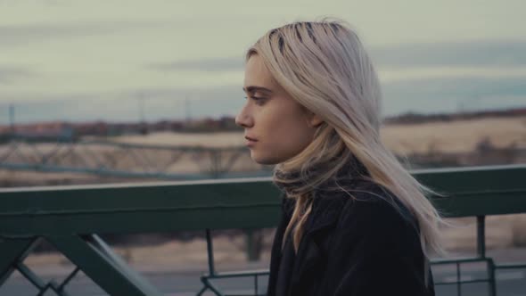 Young woman walking on pedestrian bridge