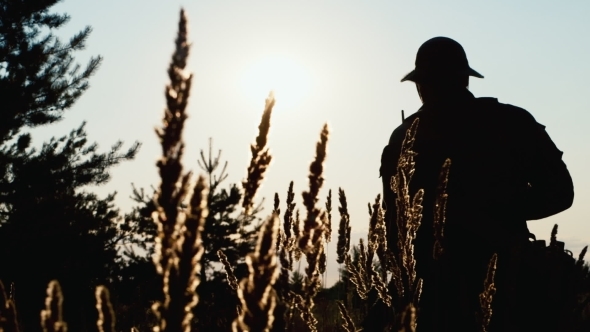 Silhouette Of a Man Takes Aim. Airsoft Game