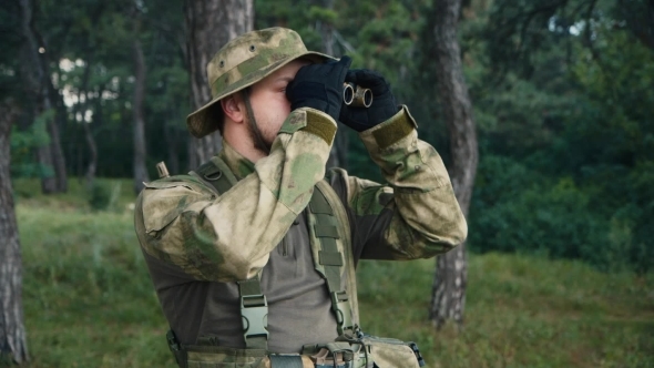 Man In Uniform Looking Through Binoculars alt